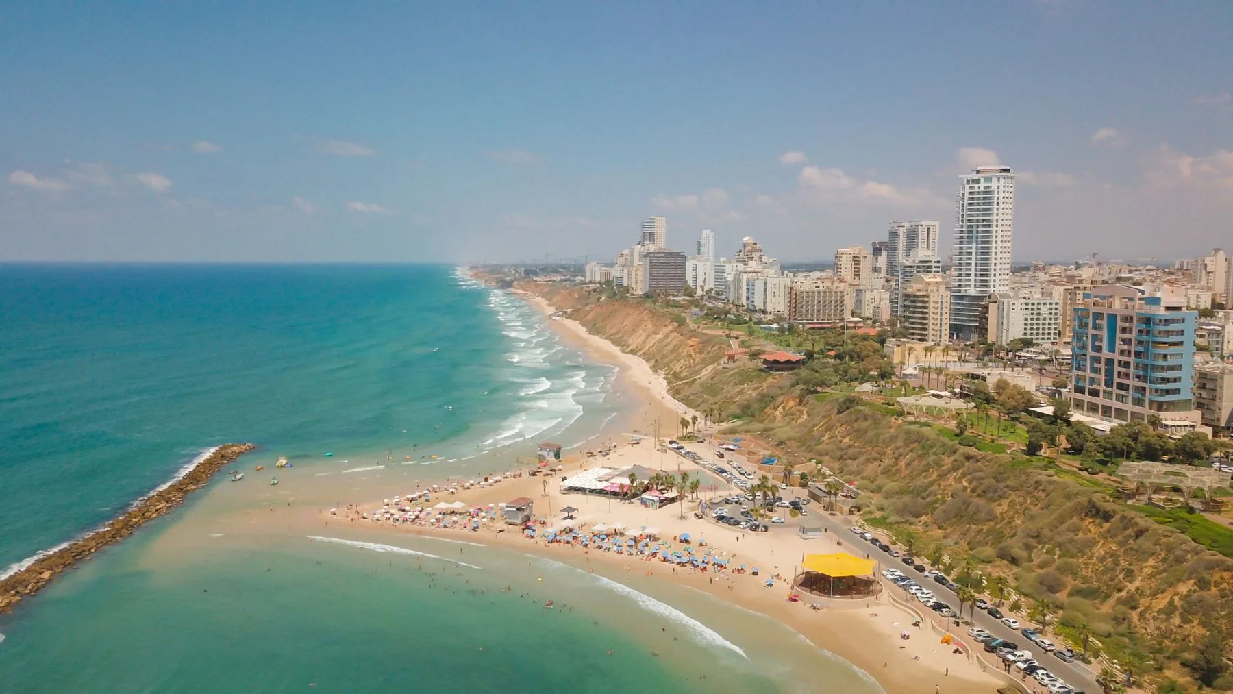 מבט מהאוויר על קו חוף עם חופים ובניינים לאורך הים